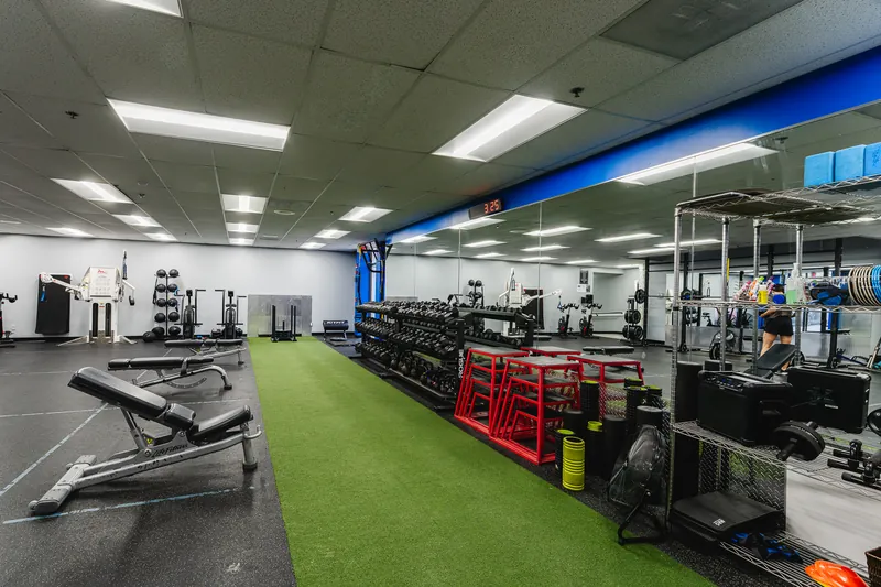 The turf lane with dumbbells and benches in the Functional Training Room at Foundation Fitness Annapolis